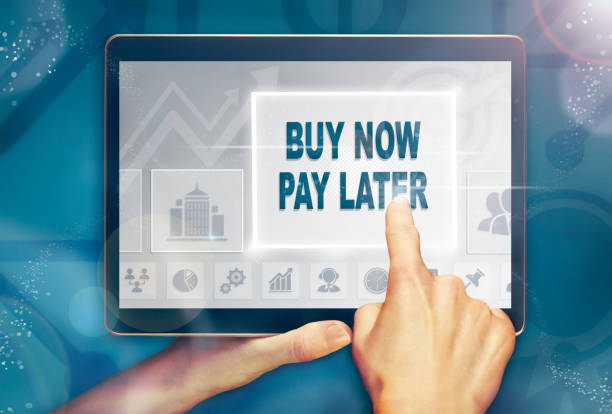 istock A hand holding a computer tablet and pressing a buy now pay later concept. 1052179302