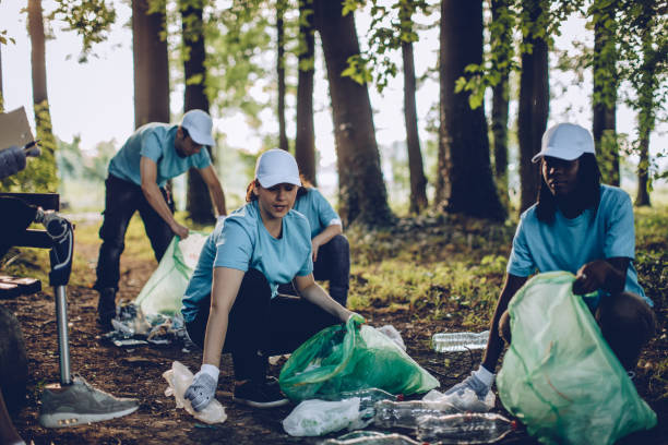 istock Group of young people cleaning park 1052191926