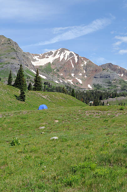 Crested Butte -- Outcast into the mountains A lone blue tent camping in a remote area under Ruby Peak, 12,644 feet and Mount. Owen, 13,058 feet. michael owen stock pictures, royalty-free photos & images