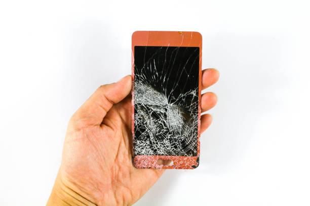 istock Mobile phone screen is broken. A man holding a mobile phone screen and The phone screen he held was cracked. 1052204410