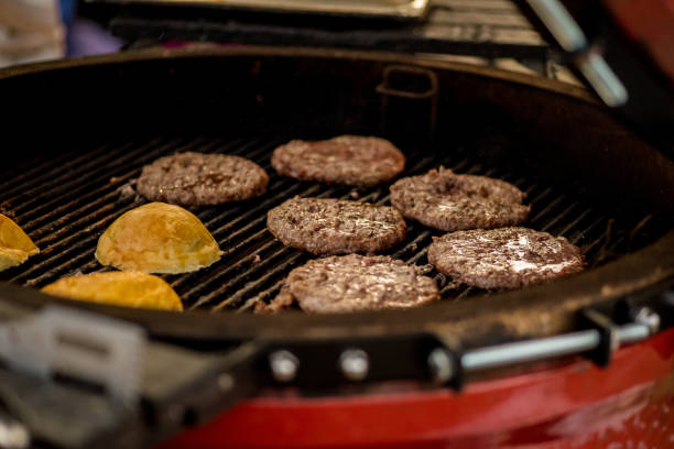 istock Rolls and burgers for burger on a round grill 1052204844