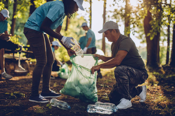 istock Volunteers with garbage bags in park 1052204924