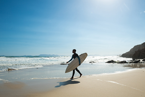 Male surfer on the coastline of Western Cape Province near Cape Town, South Africa