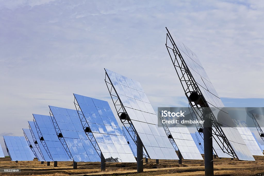 Field of Renewable Green Energy Solar Mirror Panels A field of solar mirror panels harnessing the sun's rays to provide renewable alternative green energy Mirror - Object Stock Photo