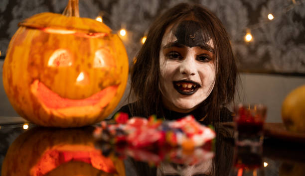 istock Cute little girl looking at camera on Halloween. 1052225140