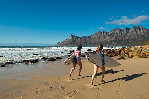 Female surfers on the coastline of Western Cape Province near Cape Town, South Africa