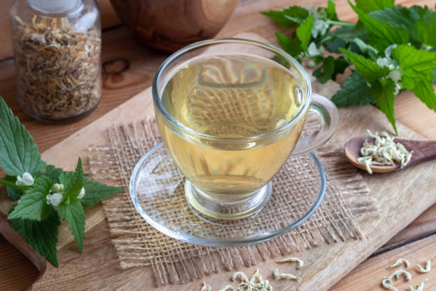 istock A cup of white dead-nettle tea with fresh and dried white dead-nettles 1052237758