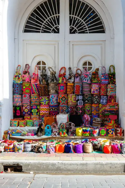 A vendor in Cartagena, Colombia, put all his Bags for sell in the entrance of a house.
