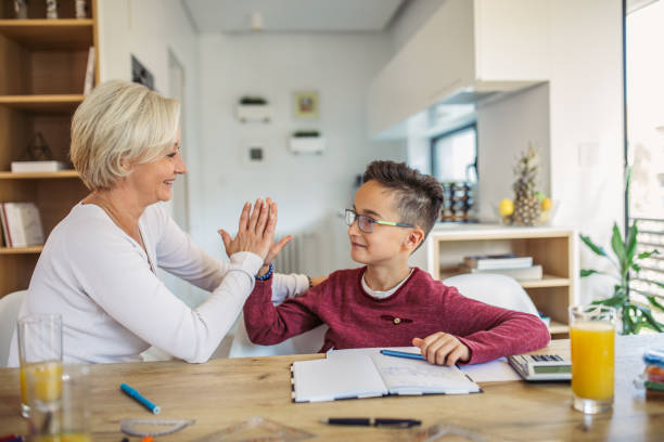 istock Mother helps son with homework at home 1052255356