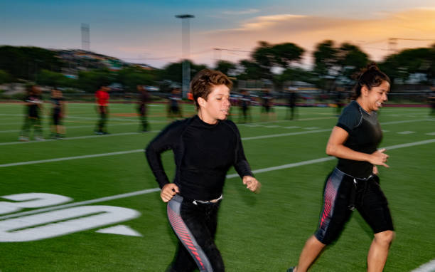 istock Female American Football Team Training 1052276384