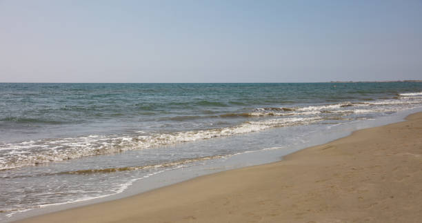 istock Sandy beach and sea water background. 1052277368