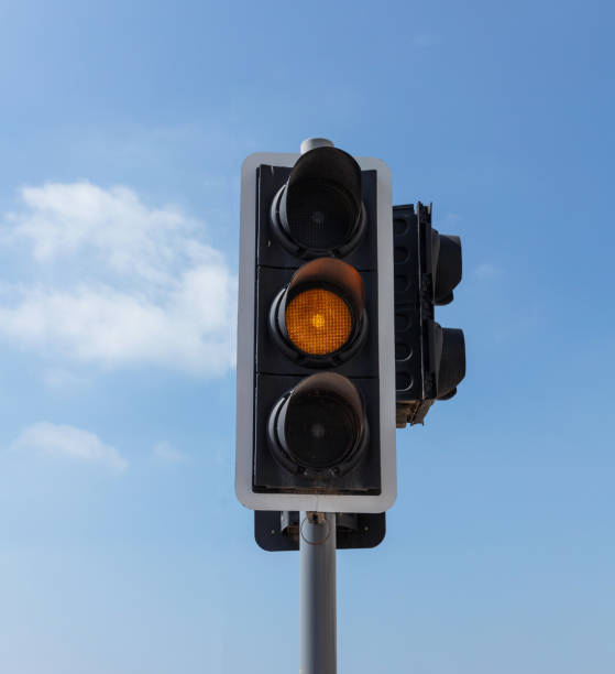 istock Orange traffic lights for cars, blue sky background 1052277376