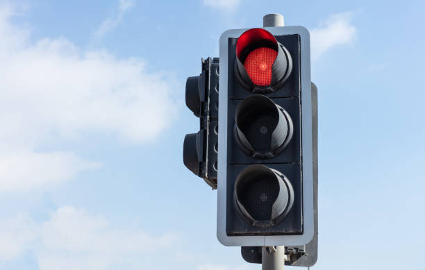 istock Red traffic lights for cars, blue sky background 1052277404