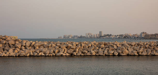 Cyprus, Larnaca view from marina over rock breakwater, blue sea and sky