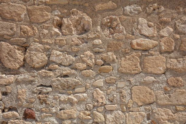 istock Traditional weathered stone wall background in Cyprus 1052277562