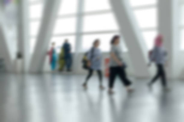 istock Unrecognizable people walking through the airport hall 1052290442