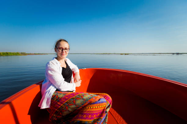 istock Girl in Red Lotus Lake 1052290766