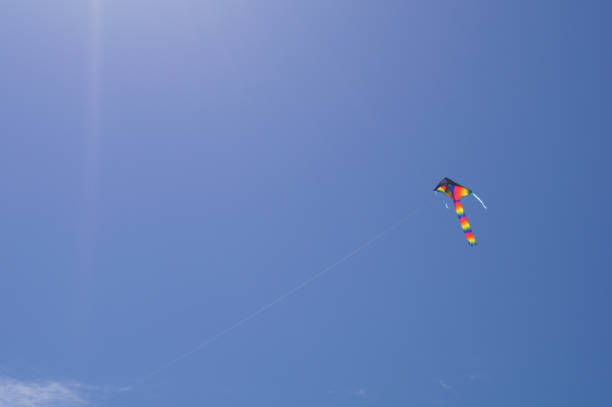 istock Flying kite into the Sun on a summer blue sky 1052299234