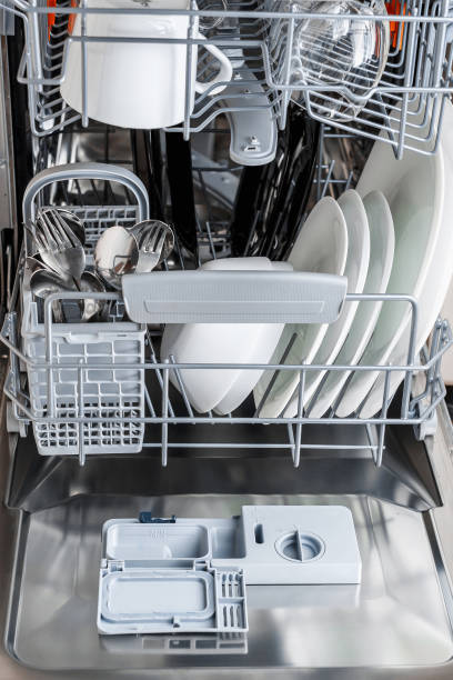 istock Open dishwasher with clean glass and dishes. 1052304026