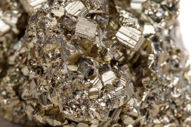 istock Macro mineral stone Pyrite gold on white background 1052317302