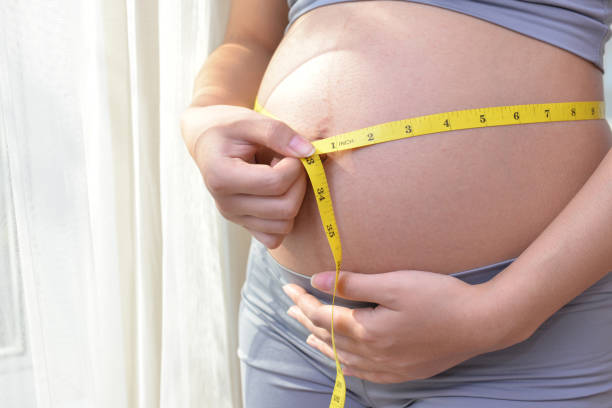 istock Pregnant girl using Waist live 1052317342