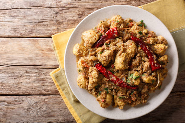 istock Indian food: Chettinad chicken curry with chili pepper closeup. horizontal top view 1052326454