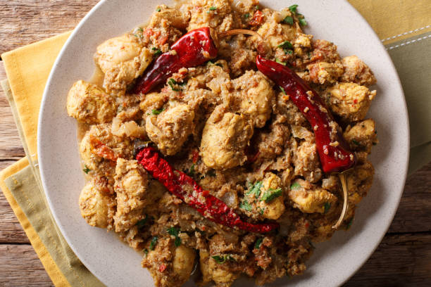 istock Indian spicy chettinad chicken curry with chili pepper closeup on a table. horizontal top view 1052328268