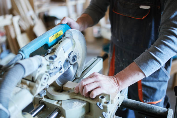 istock Crop man sawing wooden plank 1052336428