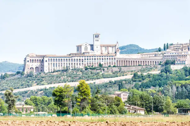 Town or village city of Assisi in Umbria, Italy cityscape of church during sunny summer day, nobody, farm rural landscape Etruscan countryside