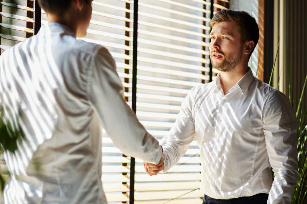 istock Coworking businessmen shaking hands 1052347372