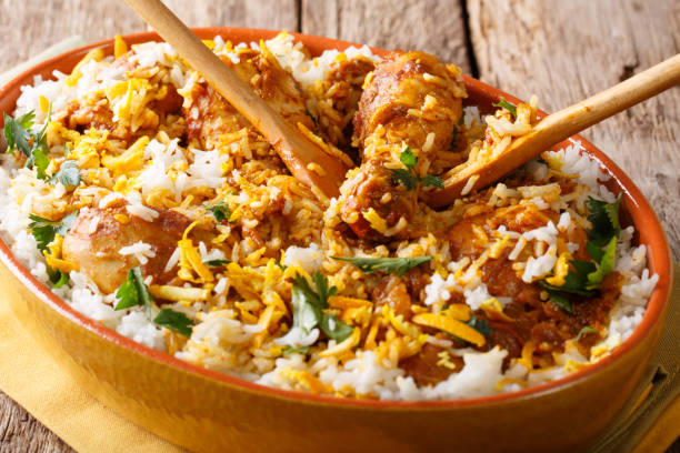 istock Indian pilaf: chicken dum biryani with lemon peel close-up in a platter. Horizontal 1052348458