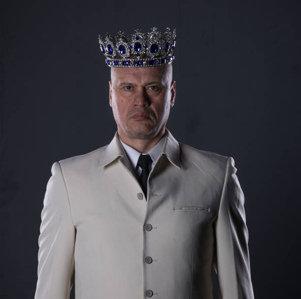 istock man in a white suit with a crown 1052355472