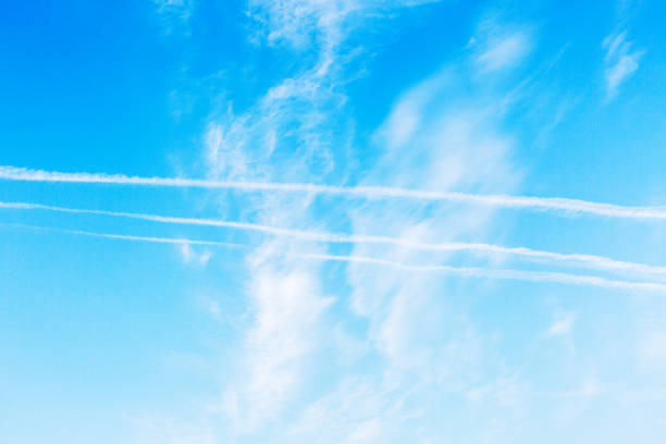 istock Blue sky with white clouds. Trace of the plane in the sky 1052360328