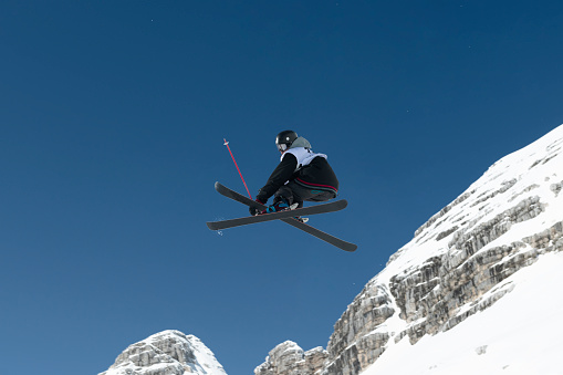 Young male skier practicing slopestyle