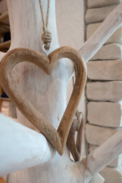 istock Christmas ornament heart shape with wooden tree branches 1052360602