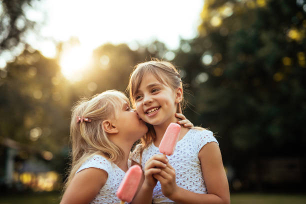 istock Two sisters enjoying an ice cream 1052362362