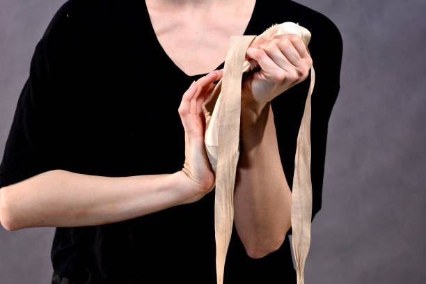 istock Stretching Feet in Pointe Shoes 1052366044