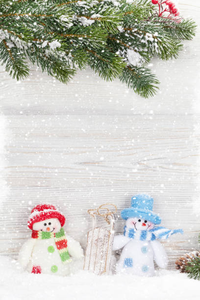 istock Christmas snowman toy, decor and fir tree branch 1052372296
