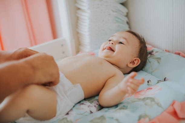 Father changing diaper Father changing diaper 2 5 months stock pictures, royalty-free photos & images