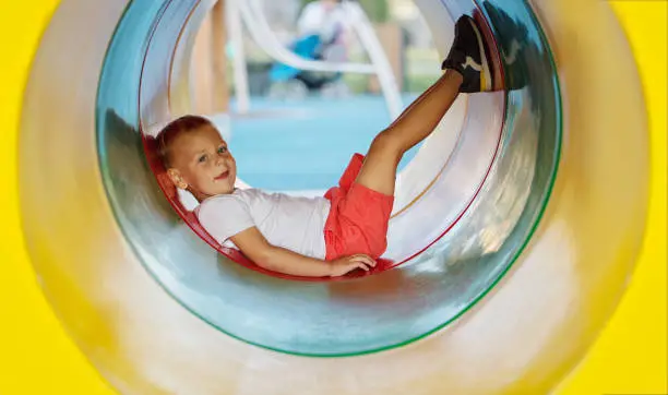 Photo of Little boy playing on the playground