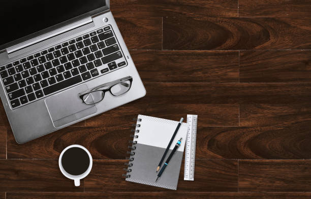 istock Home office desktop workplace with laptop with eyeglasses and notebook with copy space. Top view. 1052396894