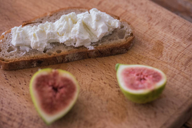 istock Snack food - rye bread slices with cheese spread and fresh fig 1052397110