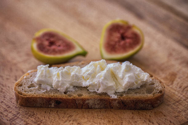 istock Snack food - rye bread slices with cheese spread and fresh fig 1052397226