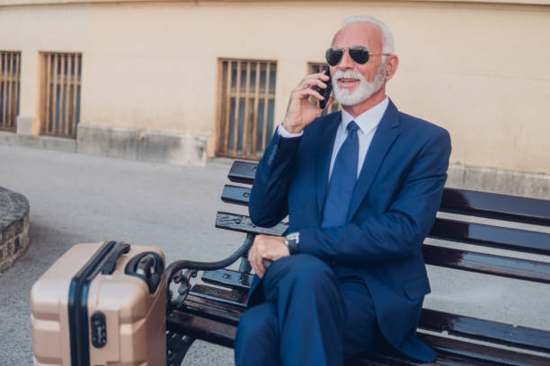 istock Senior businessman using phone outdoors 1052484766