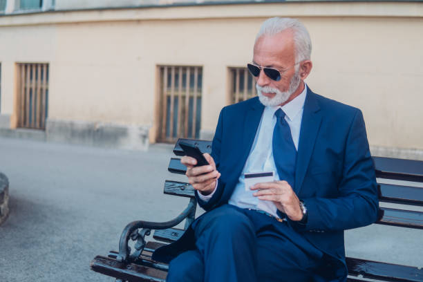 istock Businessman using mobile phone and a credit card 1052492200