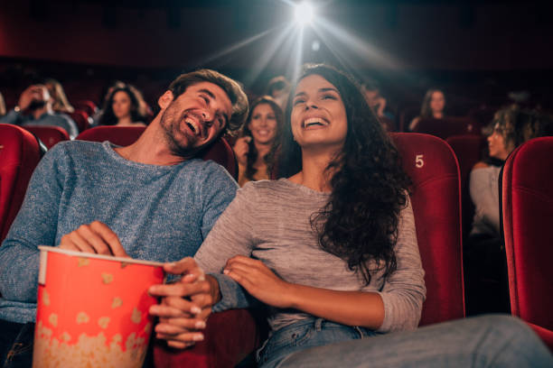 istock Couple smiling and eating popcorn at cinema 1052500466