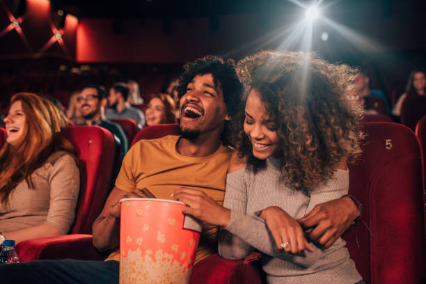 Couple in love hugging at cinema Joyful young people hugging and eating popcorn art the cinema film screening photos stock pictures, royalty-free photos & images