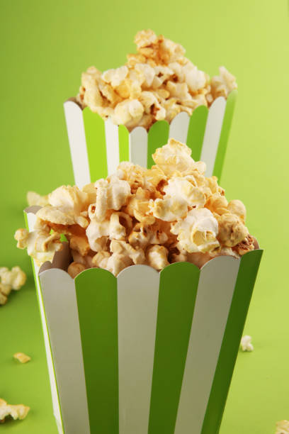 istock Cinema concept with popcorn in green white bag. 1052502690