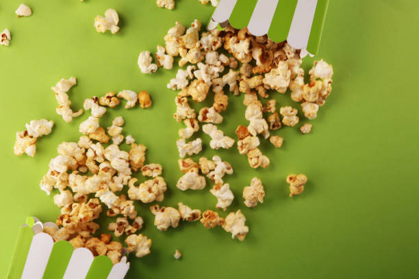 istock Cinema concept with popcorn in green white bag. 1052503782