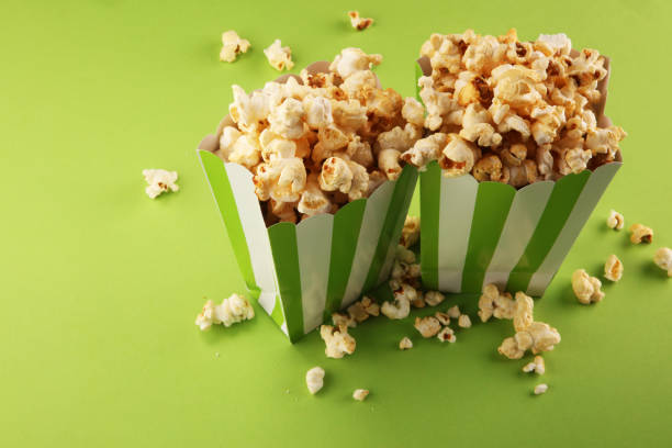 istock Cinema concept with popcorn in green white bag. 1052507040